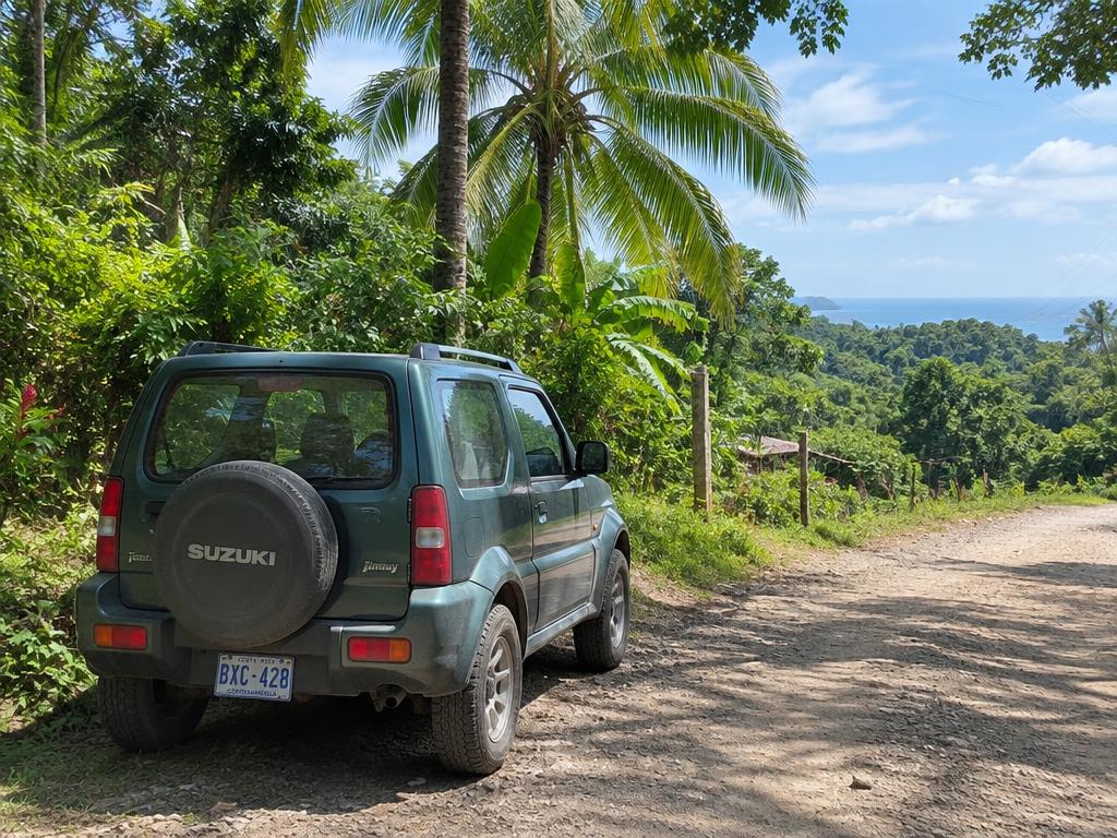 Four-wheel-drive vehicle on an unpaved tropical road